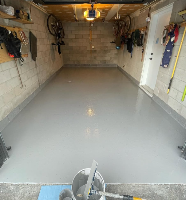 Grey epoxy garage floor with flake cove base and clean tooling